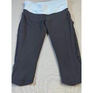 Lululemon black capri legging featuring a light blue fold-over waist ruffle trim